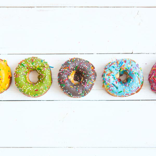 Five Dooughnuts of different colours placed in a line