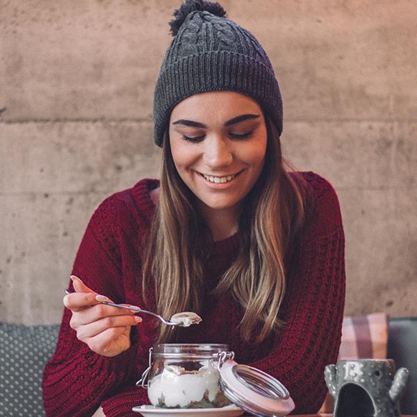 image of a woman eating yoghurt