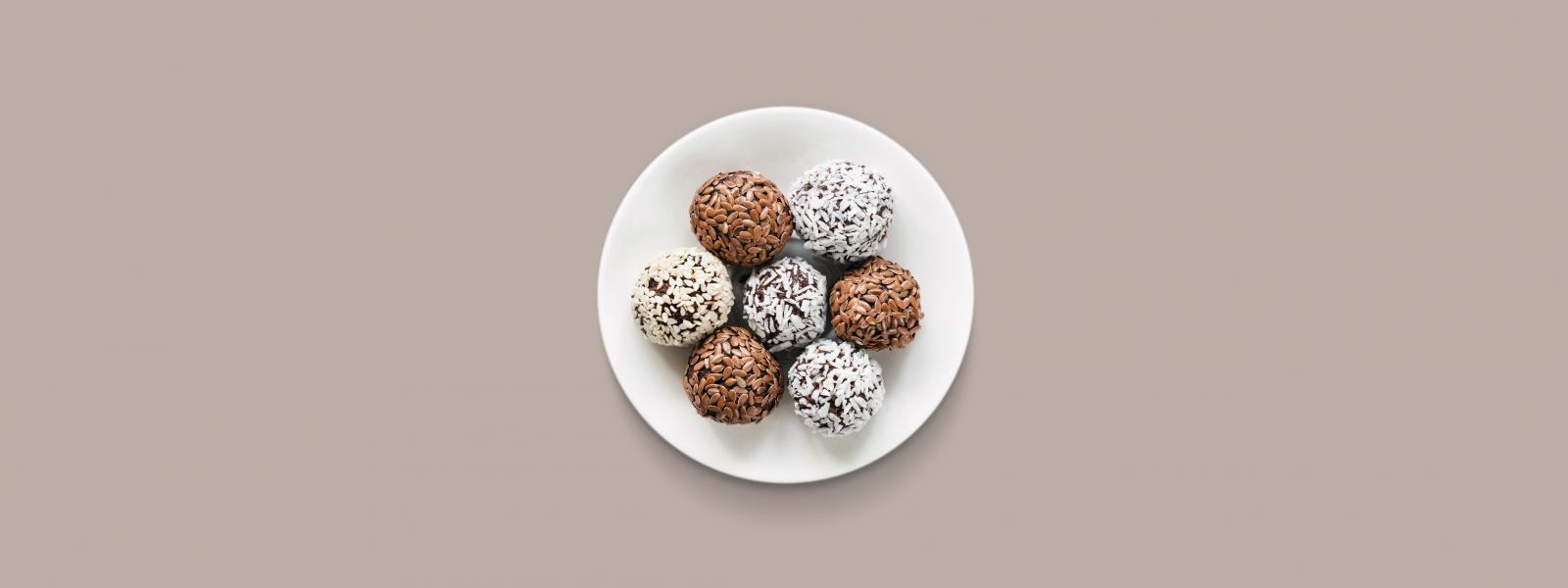 Seven protein fortified food balls on a white plate