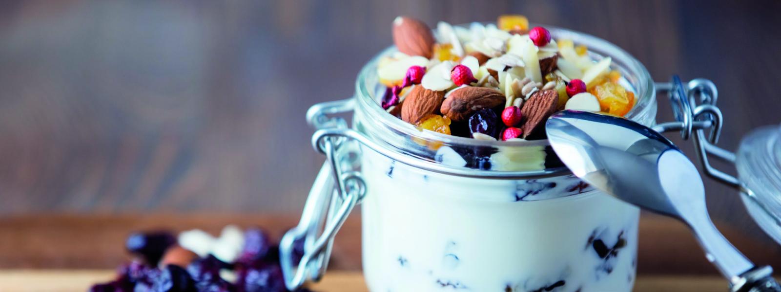 Static image of a bowl of yoghurt with nuts and berries decorating the top. 